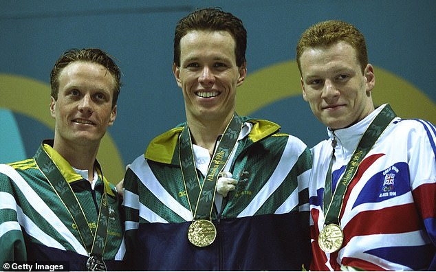 Kieren Perkins is pictured (center) after winning the 1500m at the 1996 Atlanta Olympics