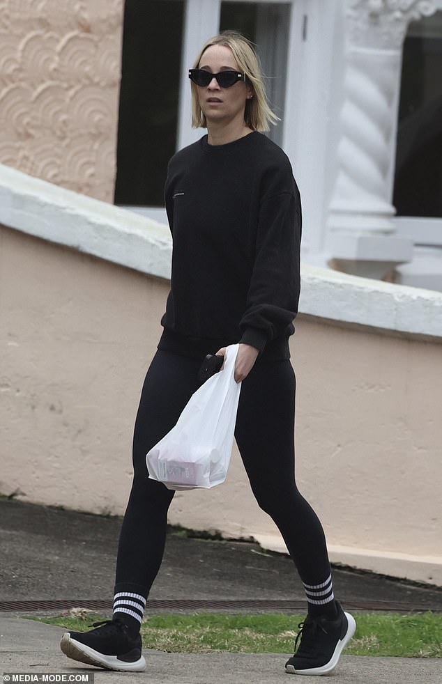 Jade completed her outfit with a simple pair of black and white sneakers, which matched perfectly with her striped socks, while she carried a plastic bag