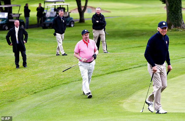 Security personnel laugh as they watch visiting US Vice President Joe Biden play in 2016