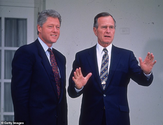 George HW Bush pictured in November 1992 with another former president, Bill Clinton