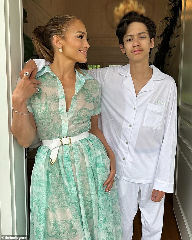 In another photo, which appears to have been taken at a different time, she is seen in a green-and-white floral dress with Max, who was wearing personalized white pajamas and had an arm around his mother's shoulder.