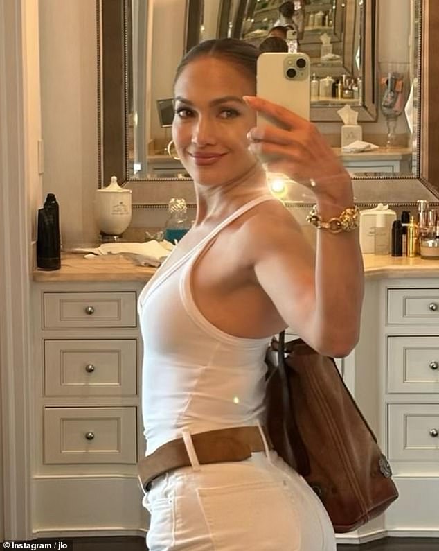 Jennifer Lopez, 54, was all smiles in a new social media post Saturday. The hitmaker shared several selfies in which she wore a white halter T-shirt with white jeans and a brown leather belt