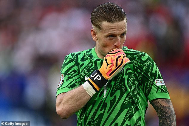 Pickford pictured kissing the crest on his England shirt during Saturday's match at Euro 2024