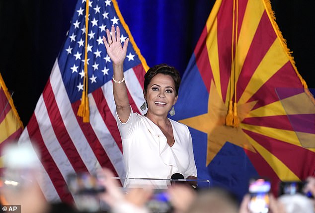 Arizona Senate Republican candidate Kari Lake waves to her supporters as she takes the stage after being declared the winner of the primary election on Tuesday, July 30, 2024, in Phoenix