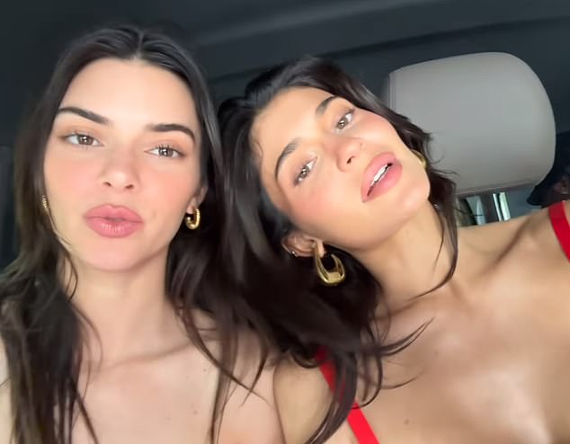 Kylie, right, seen in a red dress with sister Kendall Jenner