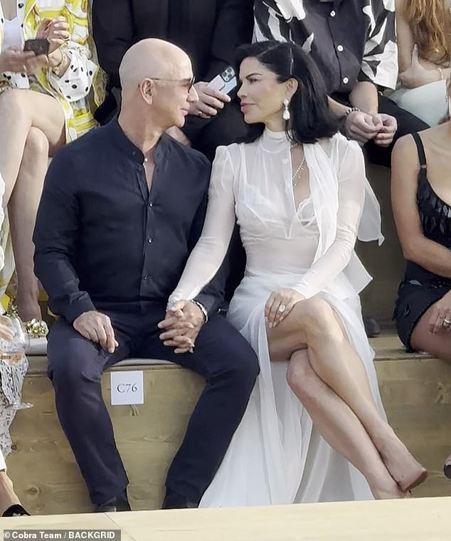 Lauren Sanchez and billionaire fiancé Jeff Bezos looked positively loved up as they sat front row at the Dolce & Gabbana fashion show in Sardinia