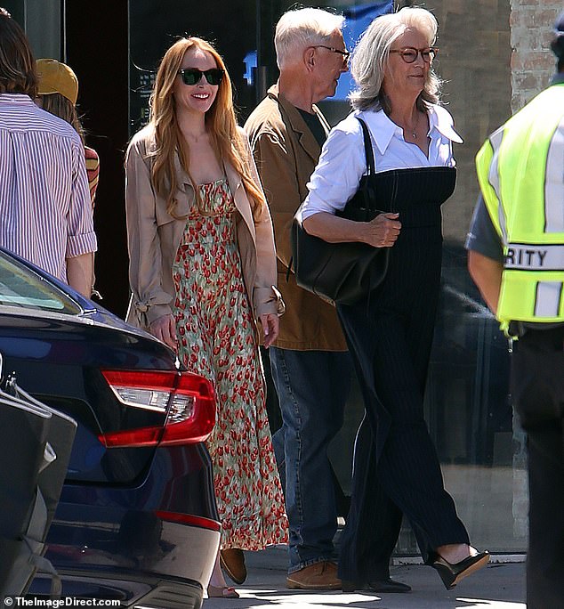 Lindsay Lohan, 38, flashed a cheerful smile as she filmed an outdoor scene for Freaky Friday 2 in Los Angeles on Monday with her co-star, Jamie Lee Curtis, 65.
