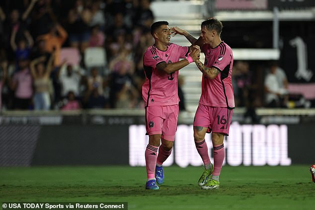 Luis Suarez celebrates with midfielder Robert Taylor after scoring a goal against Puebla