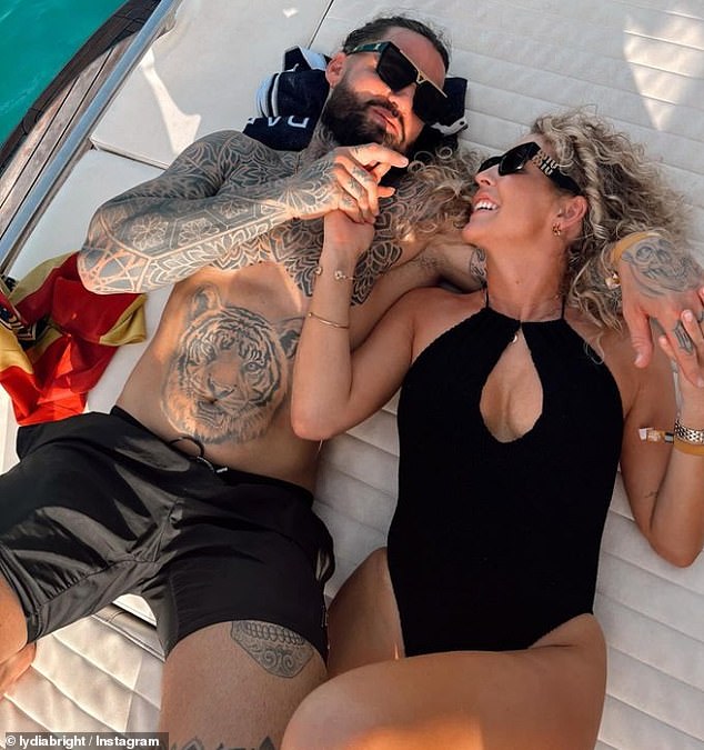 The former TOWIE star, 33, looked in love as she posed in a black swimsuit with a keyhole detail as she smiled alongside the handsome tattooed gardener