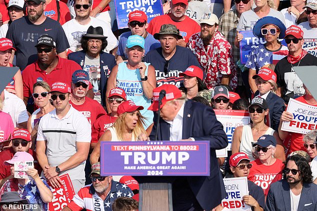 Renee White of North Carolina is seen standing right behind Donald Trump when shots rang out on July 13