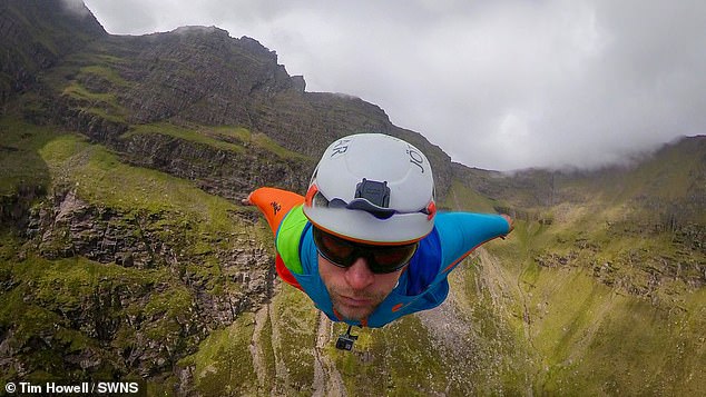 Tim Howell jumps from Lord Berkeley's Seat on the An Teallach Mountains in Scotland