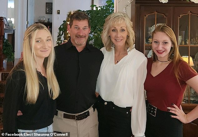 Taunton Mayor Shaunna O'Connell has been charged for allegedly biting her husband, Ted, and attacking him with a gasket scraper. They are pictured with their daughters