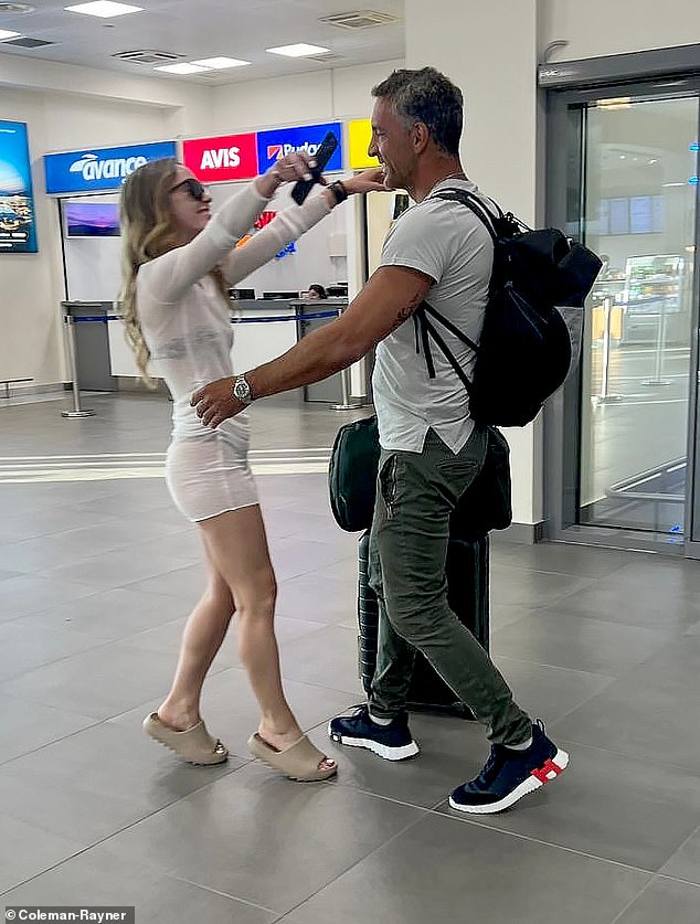 Property tycoon Umansky, 54, whose reality star ex, 55, has denied rumours of a lesbian romance with singer Morgan Wade, 29, looked happier than ever as he was greeted by a glamorous companion at Mykonos airport