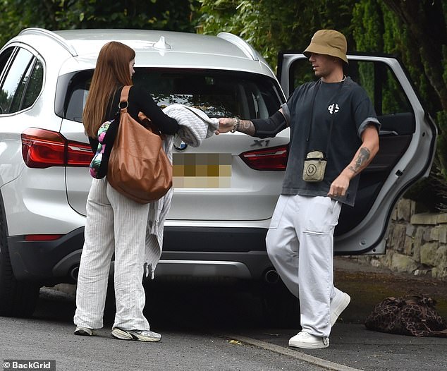 Max George, 35, showed off his elbow sleeve as he stepped out with girlfriend Maisie Smith, 22, in Manchester on Wednesday