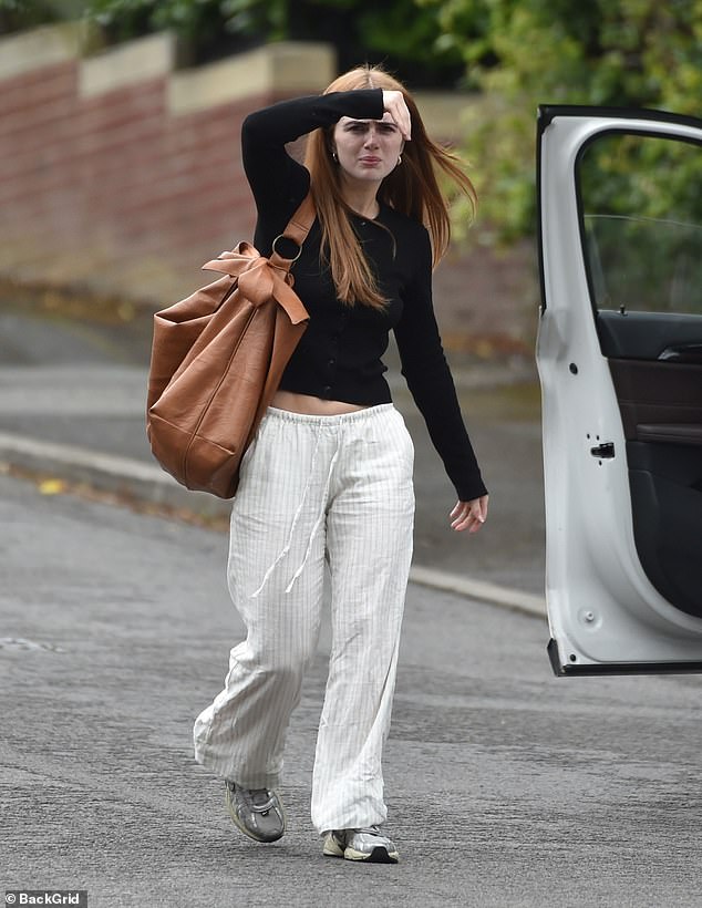Former EastEnders star Maisie kept it casual in a long-sleeved black top as she shielded her eyes from the sun with her hand