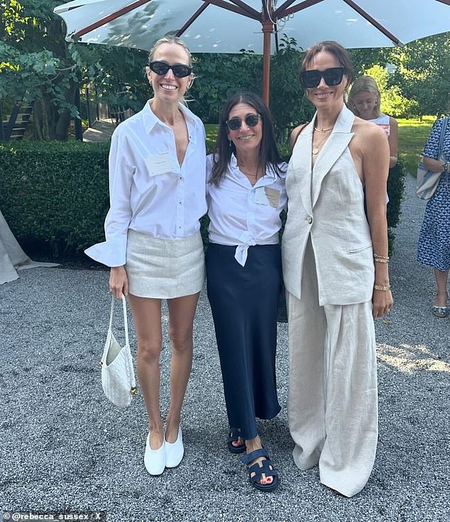 The Duchess of Sussex, pictured here alongside designer Misha Nonoo and cosmetics owner Bobbi Brown, wore a vest and trouser combo by Revolve, which retails for about $870.