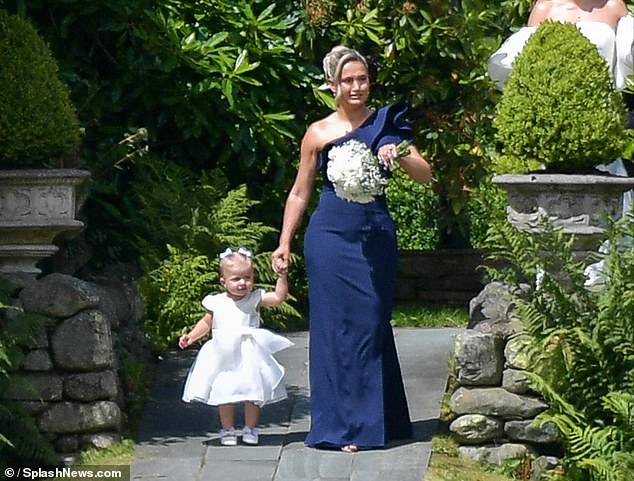 Molly-Mae Hague looked emotional as she took on the role of bridesmaid as she walked down the aisle with her daughter Bambi at her sister Zoe's wedding on Saturday