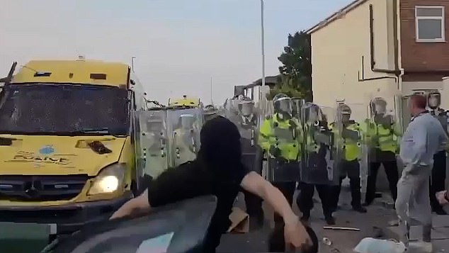 The protester was filmed ostentatiously walking towards an army of riot police officers, before putting his hands on his hips and posing