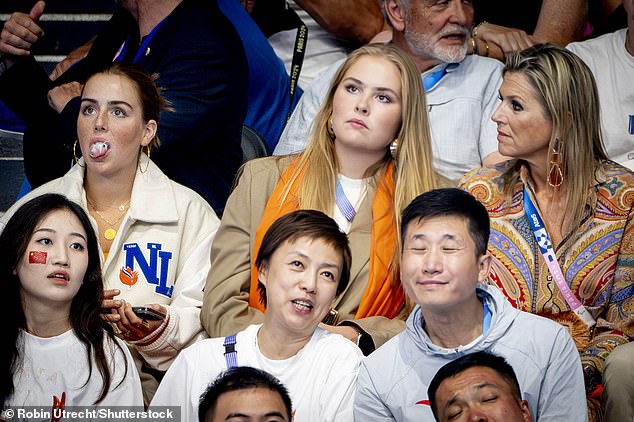 Queen Máxima (right in the photo) looks irritated as her daughter Princess Alexia (left in the photo) chews gum while watching the swimming at the Olympic Games