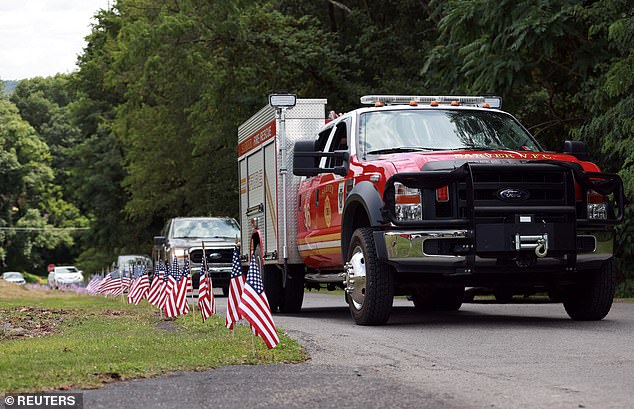 The body of Corey Comperatore was carried in a blaze, decorated with black ribbons, through his hometown of Freeport, just outside Pittsburgh, PA, on Thursday.