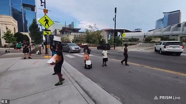 The group of children can be seen crossing the street in the city centre with their makeshift drums as the group of Nazis laugh at them.