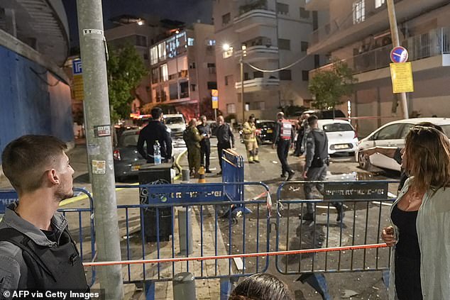 Members of the Israeli security forces are seen in a cordoned off area where the explosion occurred near the US embassy in Tel Aviv on July 19, 2024