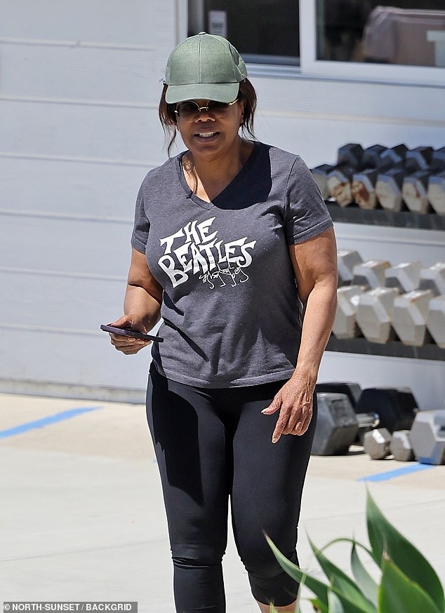 Oprah Winfrey got in a beach sweat session with her girlfriend Maria Shriver in Santa Barbara on Saturday. The Color Purple star, 70, wore a gray Beatles T-shirt and black leggings with a green baseball cap