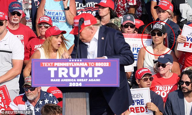 A woman in a black hat who sat behind Donald Trump as he survived an assassination attempt raised suspicions among many, who found her behavior strange