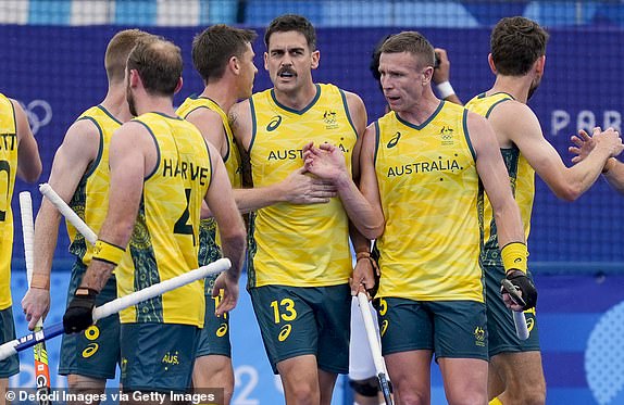 Blake Govers of Australia celebrates his team's first goal with teammates during the Men's Hockey - Pool B match between Australia and Argentina on Day 1 of the Paris 2024 Olympic Games at Yves-du-Manoir Stadium on July 27, 2024 in Colombes, France. (Photo by Alex Gottschalk/DeFodi Images via Getty Images)