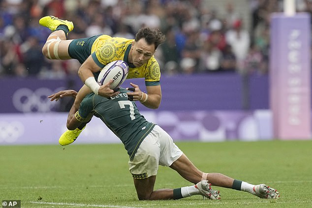 Australia's Hayden Sergeant is tackled during the heartbreaking loss to South Africa, which saw captain Nick Malouf sent off for a high shot