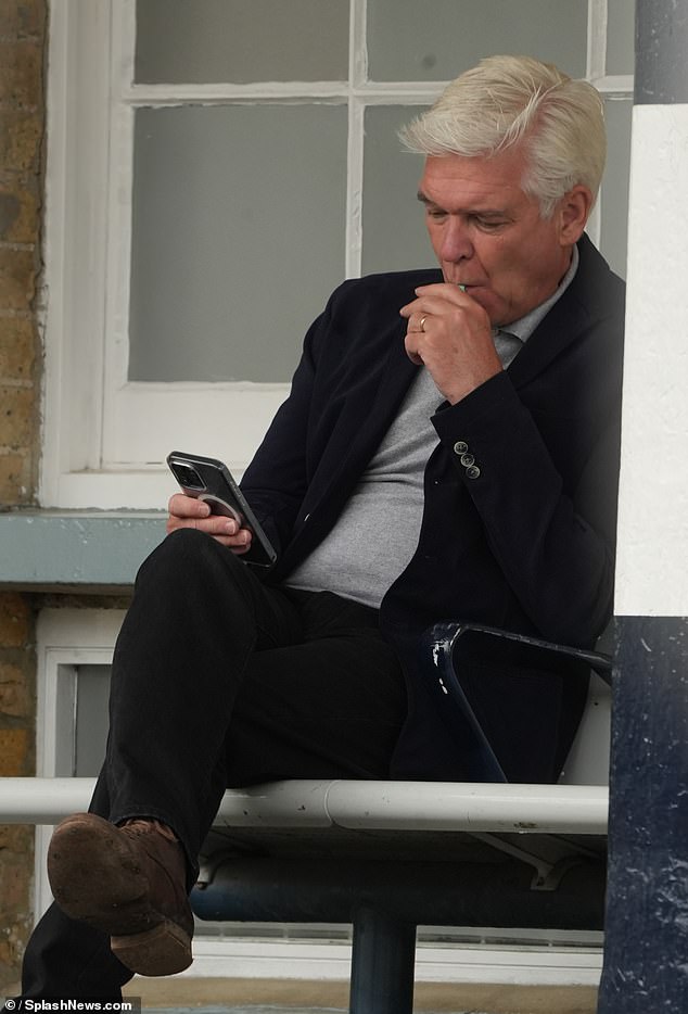 Phillip Schofield was spotted puffing on an e-cigarette at a west London train station, despite all forms of smoking being banned