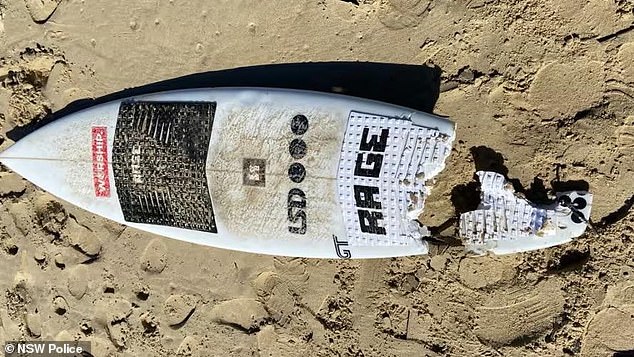 Mr McKenzie's surfboard is on display after the horrific shark attack at North Shore Beach in Port Macquarie on July 23