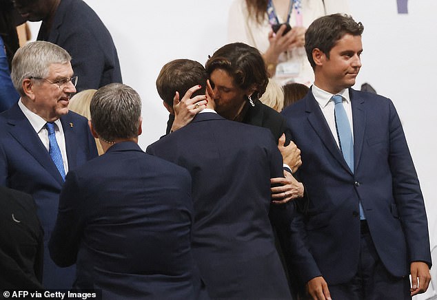 French Prime Minister Gabriel Attal, right, looks away as the two share a passionate kiss