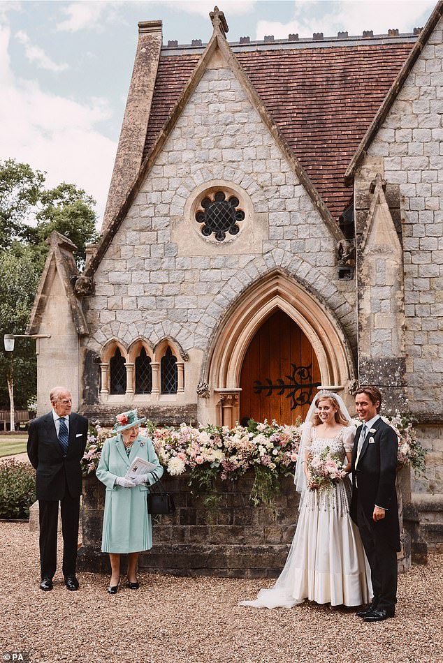 Queen Elizabeth II and Prince Philip stand next to Princess Beatrice and Edoardo Mapelli Mozzi outside the Royal Chapel of All Saints at Royal Lodge, Windsor, after their wedding