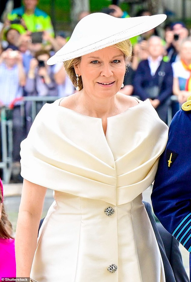 The Queen teamed her chic dress with a pair of brown suede gloves, which perfectly matched her high heels