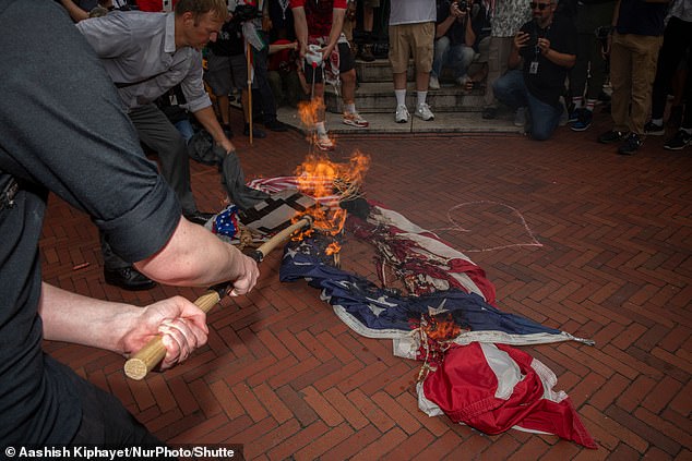 Protesters set fire to an American flag at Union Station