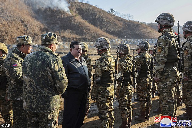 Kim Jong Un meets with soldiers during a visit to a Western operational training base in North Korea