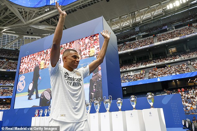 Kylian Mbappe waves to fans during his presentation ceremony at Real Madrid on July 16