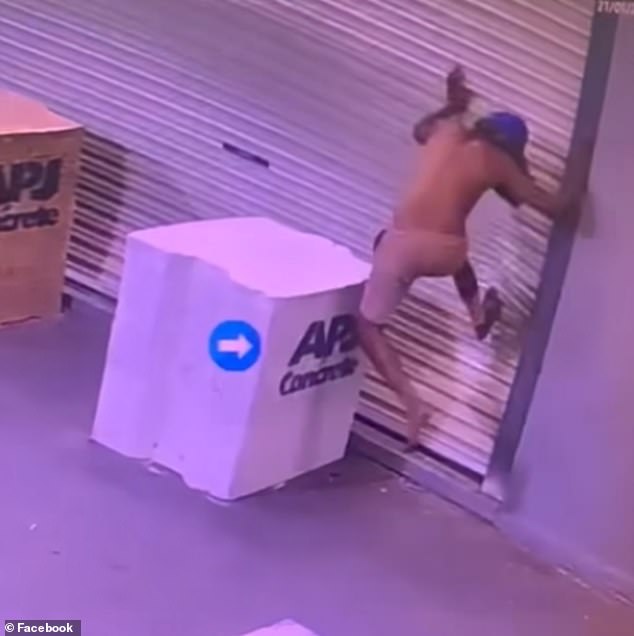 The young man hits his feet against the liquor store door