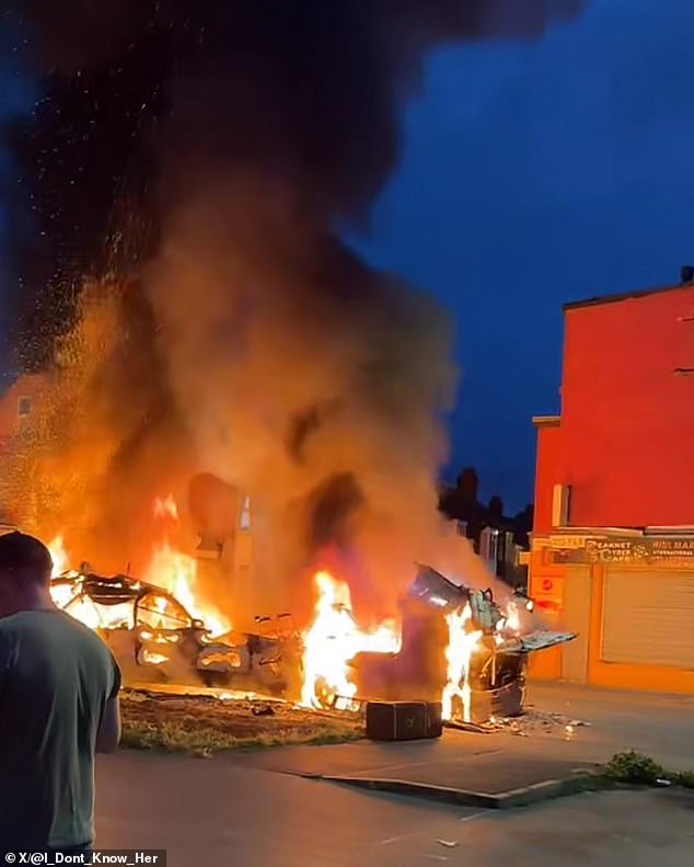 The double-decker bus was left a twisted and smoldering wreck after being set alight