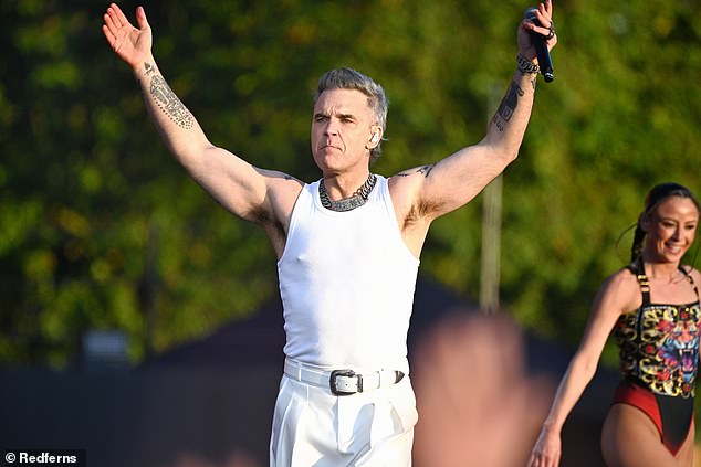 Robbie Williams was joined by Danny Dyer and a Beefeaters band for a rousing cover of Parklife during his performance in London on Saturday night.