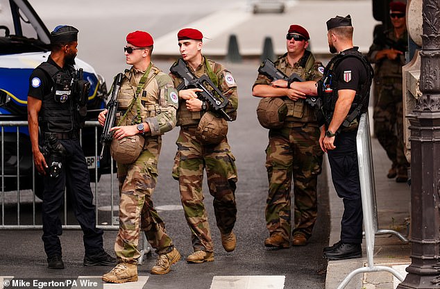 Armed guards have been spotted patrolling metal barricades erected near the River Seine in Paris ahead of the start of the Olympic Games