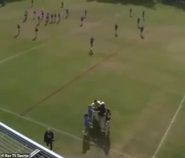 A spectator and a Kangaroos player got into a fight during the one-sided match, which caused both teams to rush inside (photo)