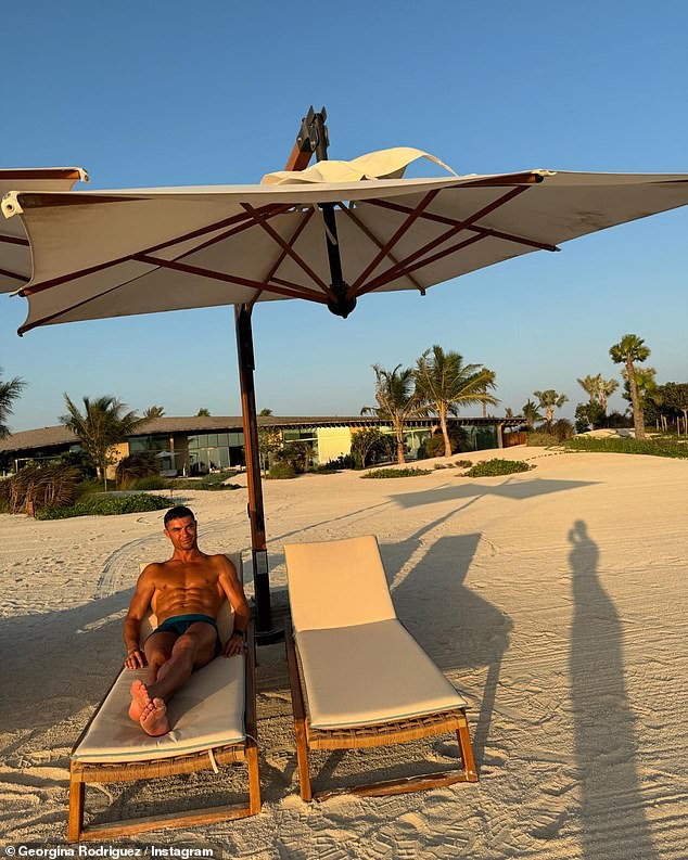 Shirtless Ronaldo relaxes on a lounger and enjoys the sun