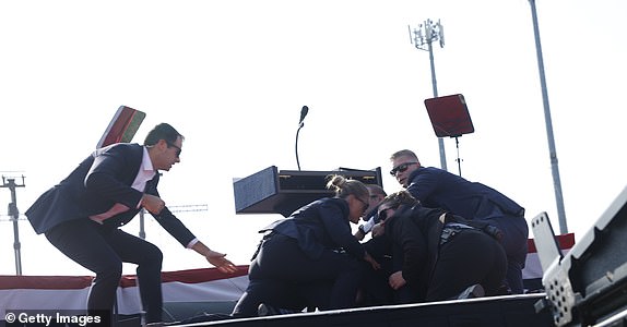 BUTLER, PENNSYLVANIA - JULY 13: Republican presidential candidate and former President Donald Trump is escorted off the stage during a rally on July 13, 2024 in Butler, Pennsylvania. (Photo by Anna Moneymaker/Getty Images)