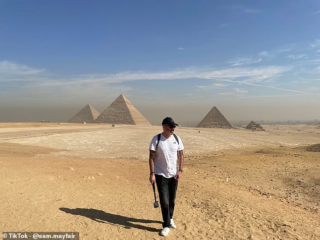 Egyptology enthusiast and TikToker Sam Mayfair produced a video answering the question: Should I visit Cairo or Luxor in Egypt? He is pictured above at the Giza pyramid complex near Cairo