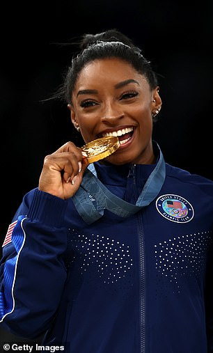 Gold medalist Simone Biles of Team United States poses on the podium