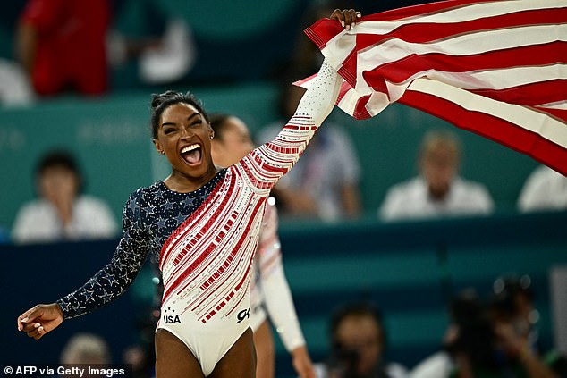 USA's Simone Biles celebrates the US team's victory in the women's team artistic gymnastics final