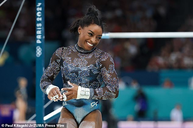 Biles smiles after a match on the uneven bars during Sunday's competition in Paris