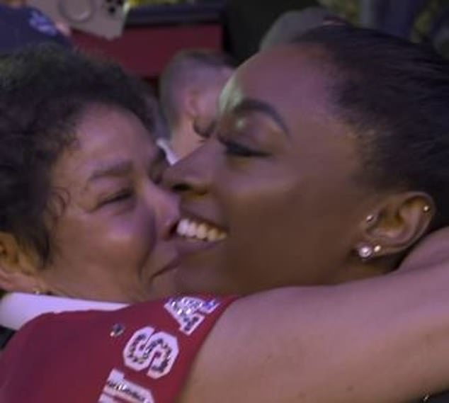 Simone Biles hugs her adoptive mother, Nellie Biles, after winning team gold for the U.S.